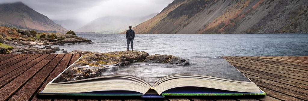 Open book with a man standing at a rocky shore in the background